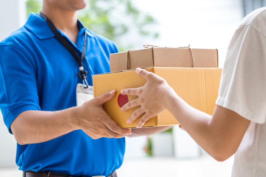 52450552 – woman hand accepting a delivery of boxes from deliveryman