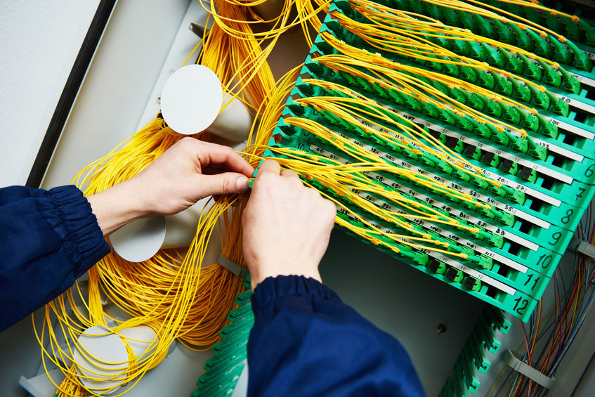internet connection. engineer connecting fiber optic cables