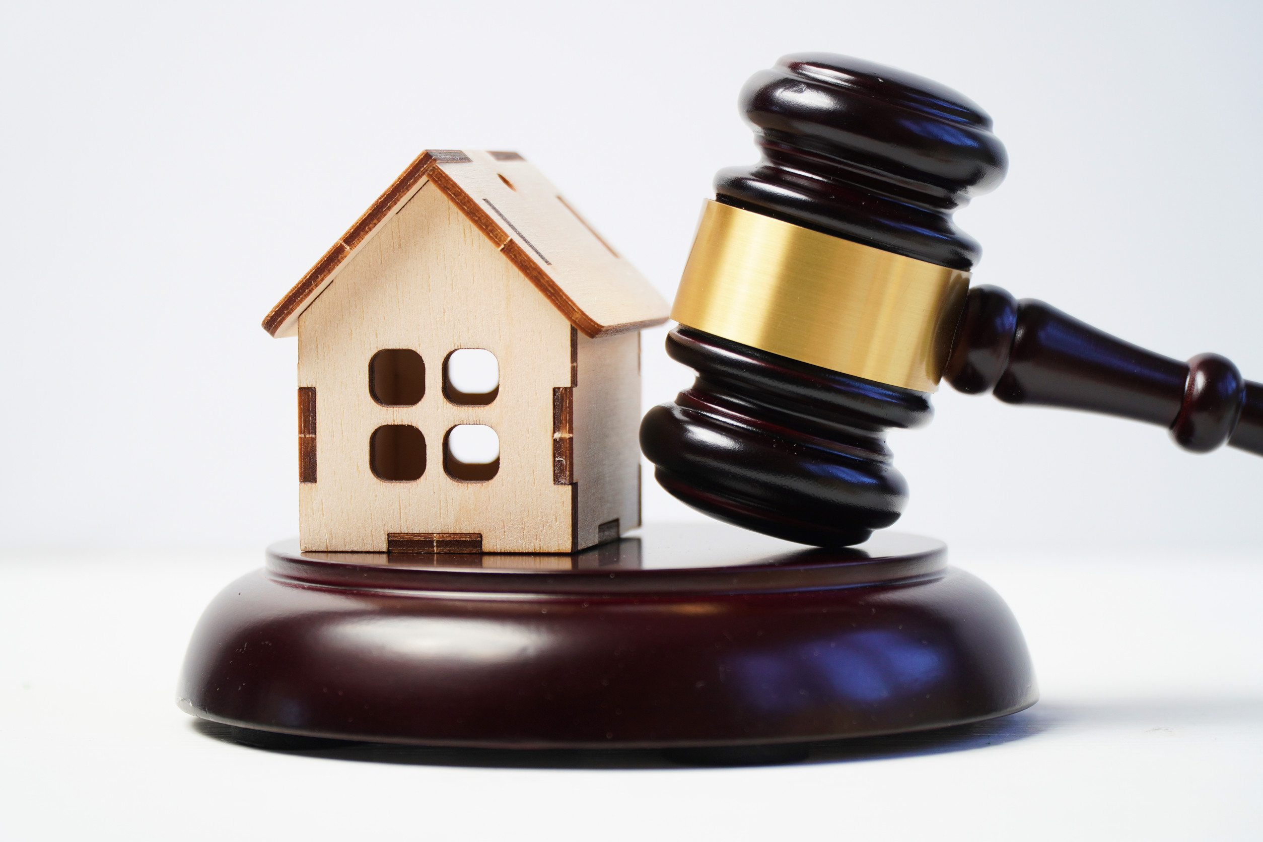 Wooden model of a house with a judge’s gavel. The concept of judicial property cases.