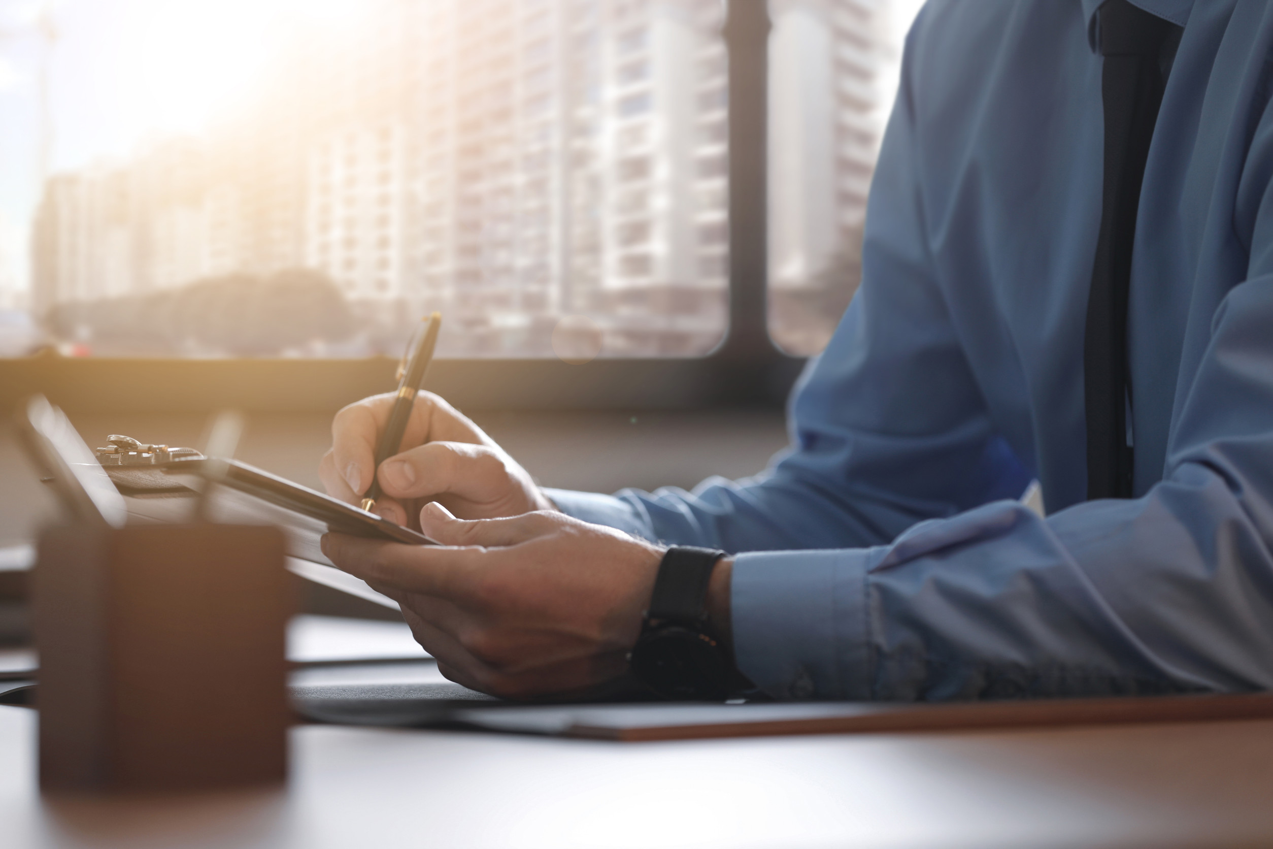 Male lawyer working at table in office, closeup