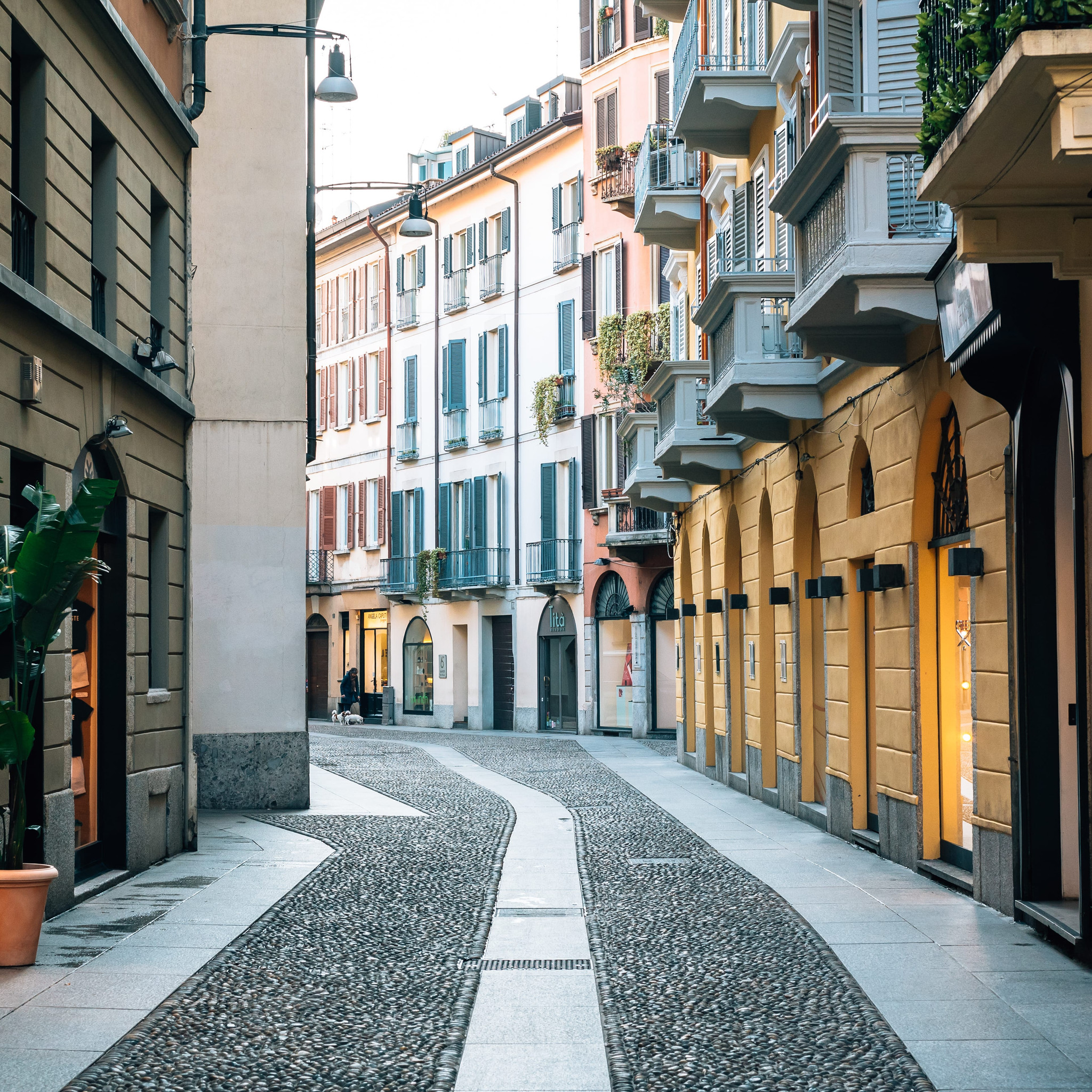 A colorful cobblestone street in Brera, Milan, Italy.